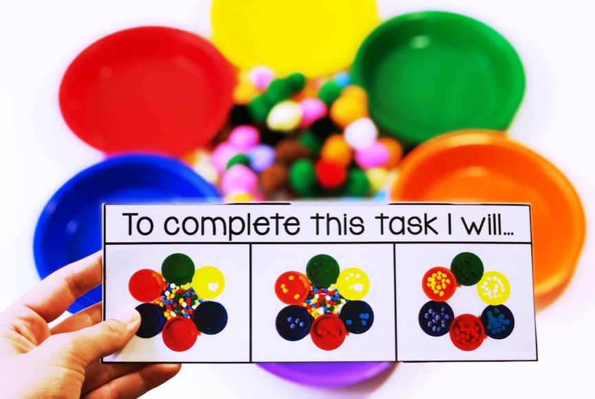 sorting pom poms into colored bowls task boxes